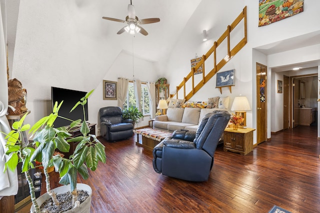 living room with ceiling fan, dark wood-type flooring, and high vaulted ceiling