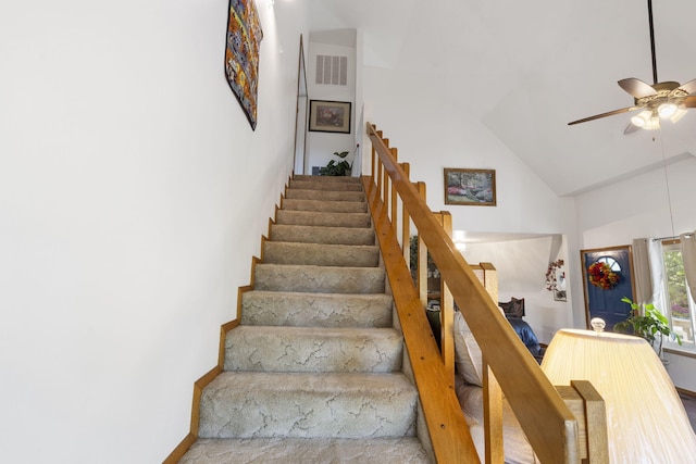 staircase featuring high vaulted ceiling and ceiling fan