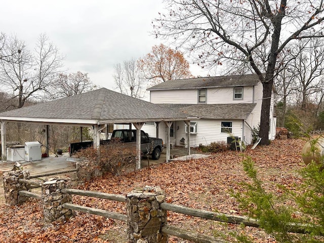 rear view of house featuring a carport