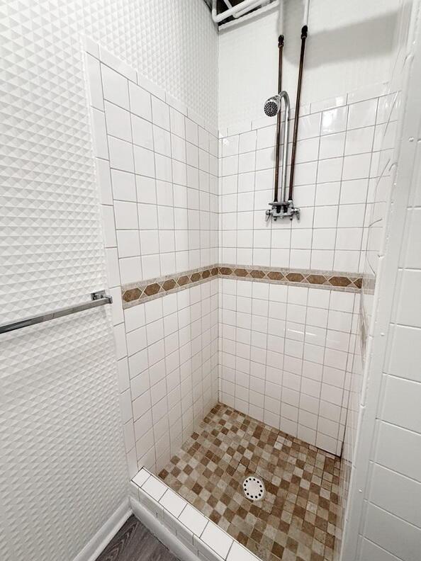 bathroom with tiled shower