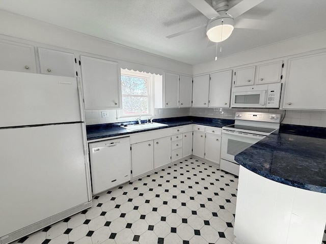 kitchen with white cabinetry, sink, and white appliances