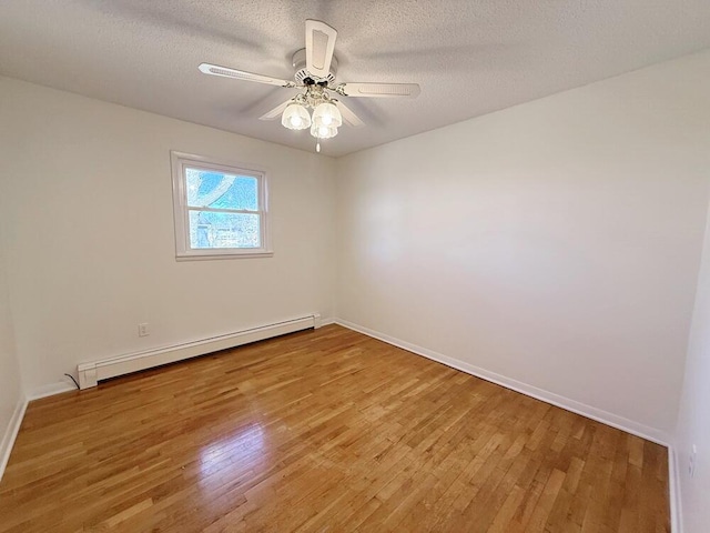 unfurnished room featuring ceiling fan, a baseboard radiator, a textured ceiling, and wood-type flooring