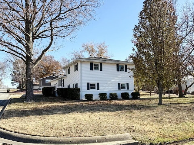 view of property exterior featuring a lawn