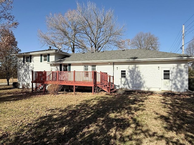 back of property featuring a lawn and a wooden deck