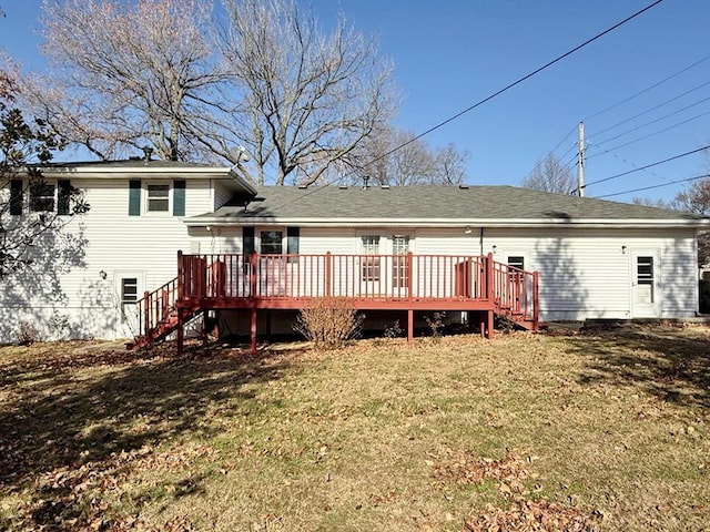 rear view of property featuring a lawn and a wooden deck