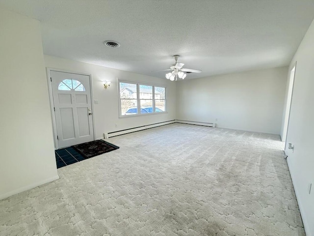 carpeted entrance foyer with ceiling fan, a textured ceiling, and a baseboard heating unit