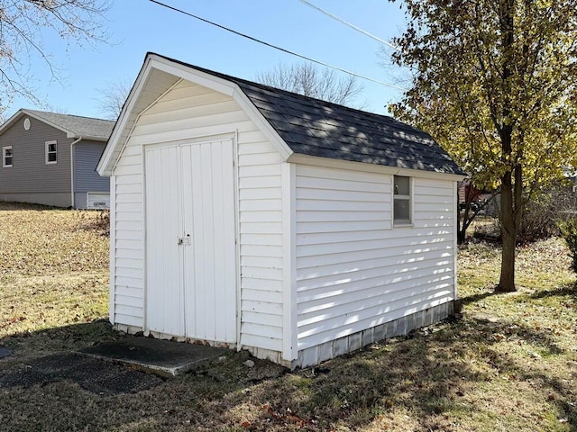 view of outbuilding featuring a yard