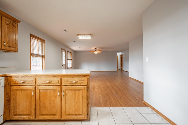 kitchen with white dishwasher, ceiling fan, light wood-type flooring, and kitchen peninsula