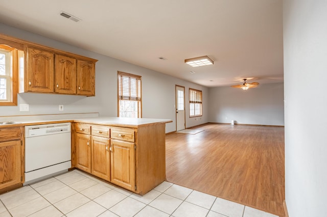 kitchen featuring white dishwasher, ceiling fan, light hardwood / wood-style floors, and kitchen peninsula