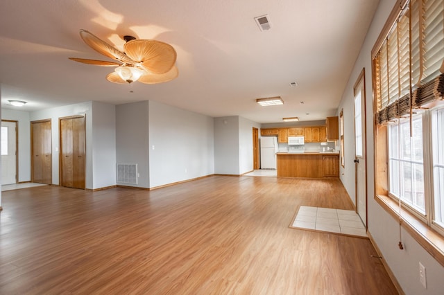 1204 Lake Road Dr, Cassville, MO 65625 - unfurnished living room featuring light wood finished floors and a ceiling fan