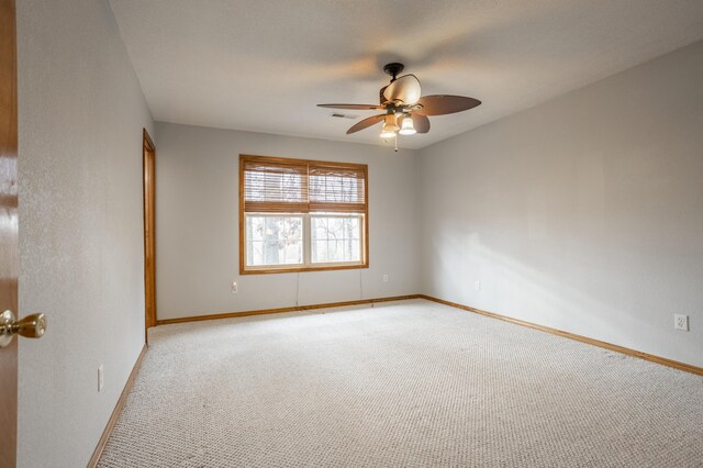 unfurnished room featuring ceiling fan and light colored carpet