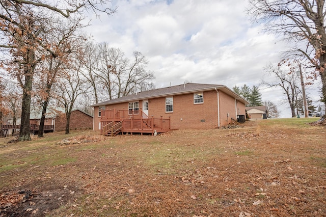 1204 Lake Road Dr, Cassville, MO 65625 - back of house featuring brick siding, a wooden deck, and a yard