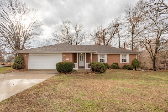 ranch-style house with covered porch, a garage, and a front lawn