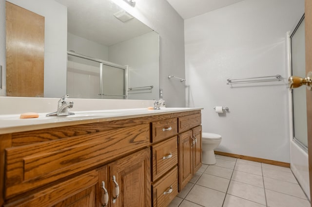 full bathroom with toilet, vanity, tile patterned floors, and enclosed tub / shower combo