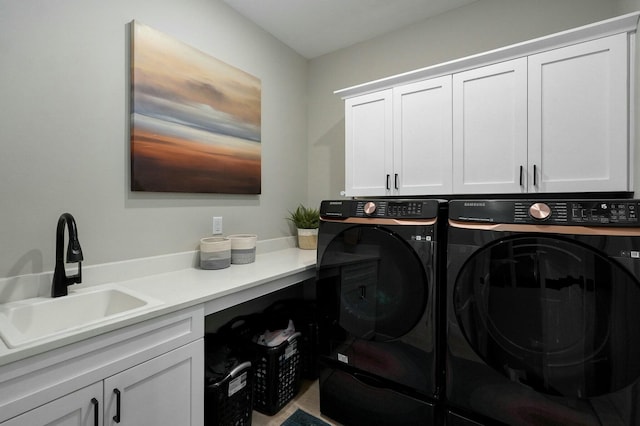 laundry room with washer and clothes dryer, cabinets, and sink