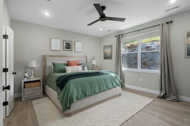 bedroom with light wood-type flooring and ceiling fan