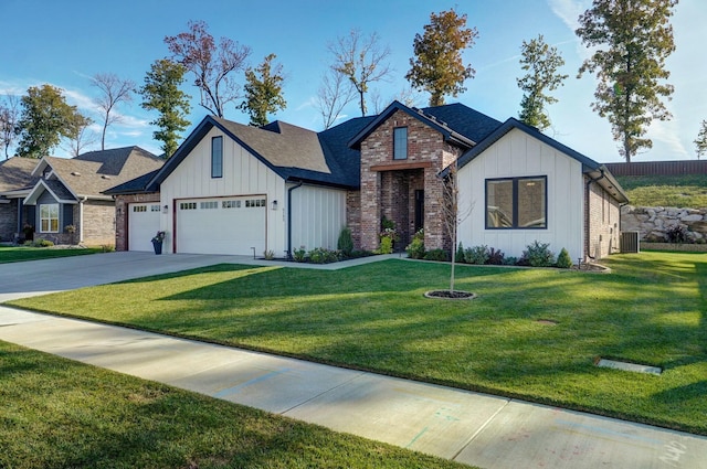 view of front of property featuring a garage, central air condition unit, and a front yard