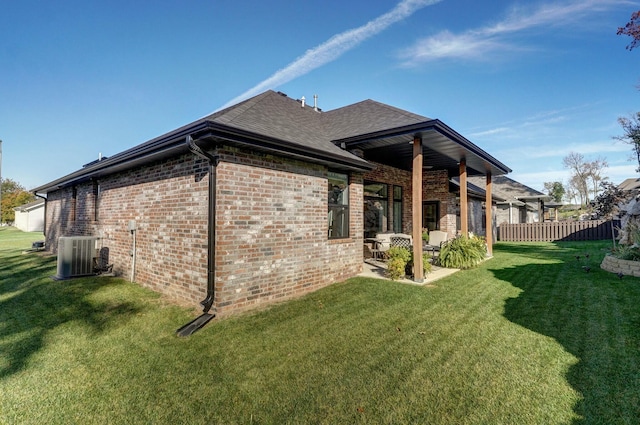 view of property exterior with a yard, cooling unit, and a patio area