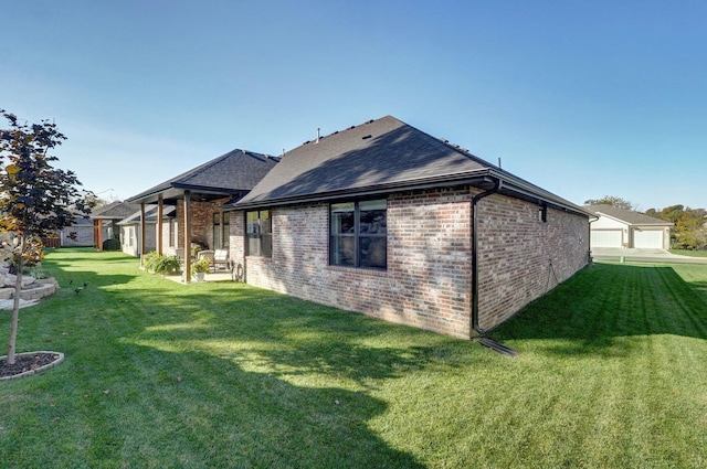 rear view of property featuring a lawn