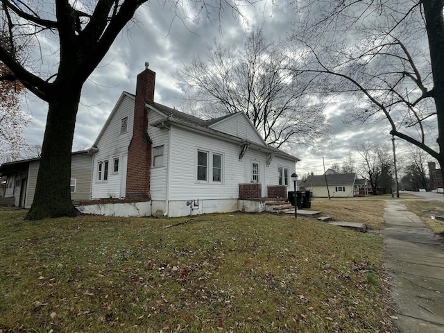 view of side of property with a lawn