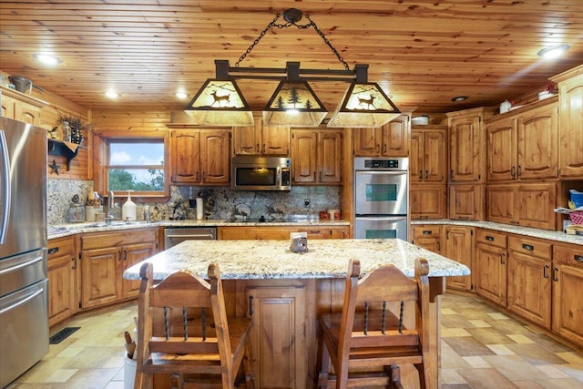 kitchen with a center island, sink, a breakfast bar area, tasteful backsplash, and stainless steel appliances