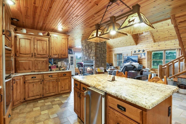 kitchen with a wood stove, stainless steel appliances, decorative light fixtures, a kitchen island, and wood ceiling