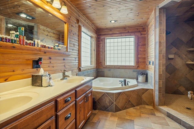 bathroom with vanity and independent shower and bath