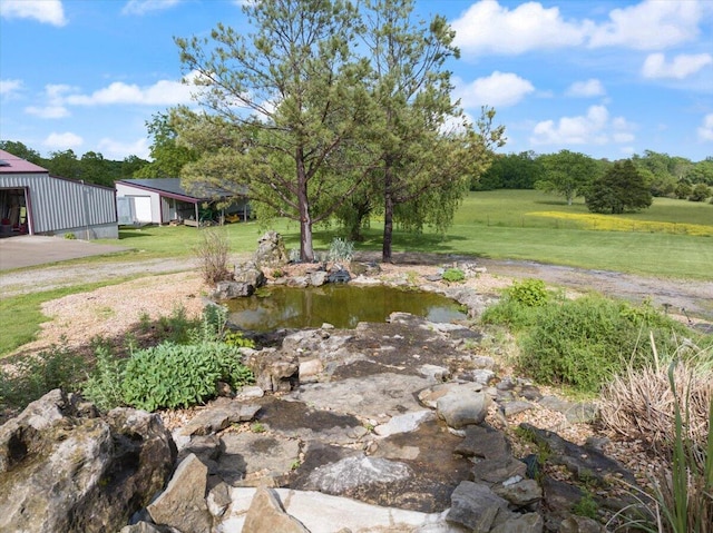 view of yard featuring a garage and an outdoor structure