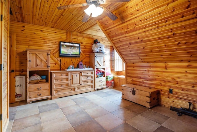 interior space featuring ceiling fan, wood walls, wooden ceiling, and vaulted ceiling