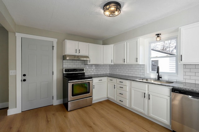 kitchen with stainless steel appliances, white cabinetry, and sink