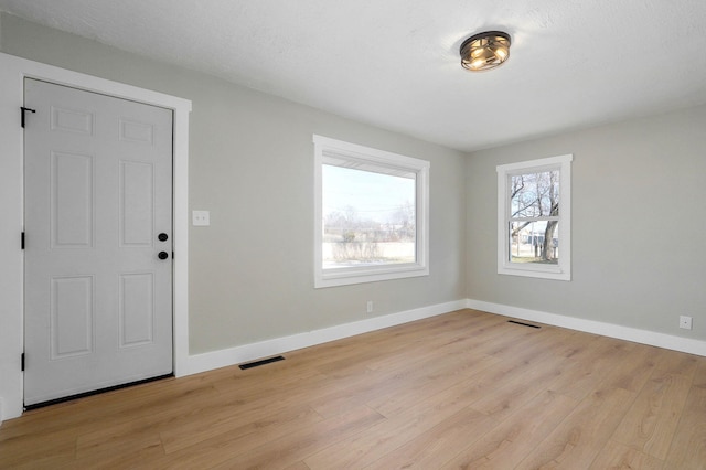 foyer entrance with light wood-type flooring