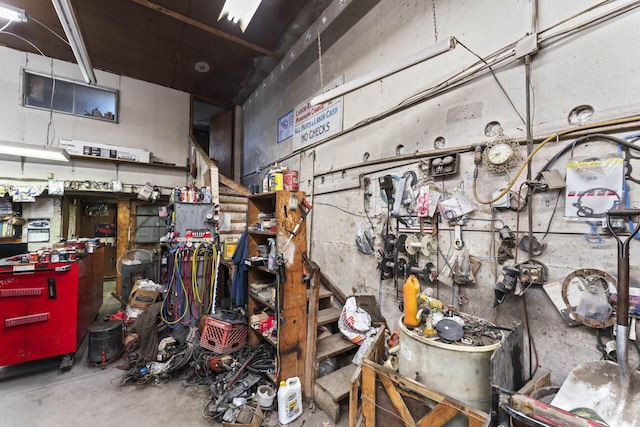 miscellaneous room featuring a workshop area and concrete flooring