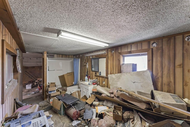 misc room featuring wooden walls and a textured ceiling