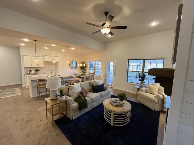 living area with recessed lighting, baseboards, light wood-style flooring, and a ceiling fan