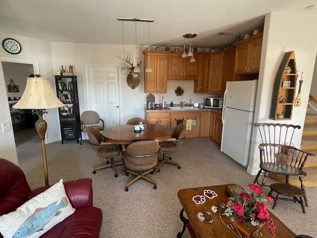 kitchen featuring white fridge and hanging light fixtures