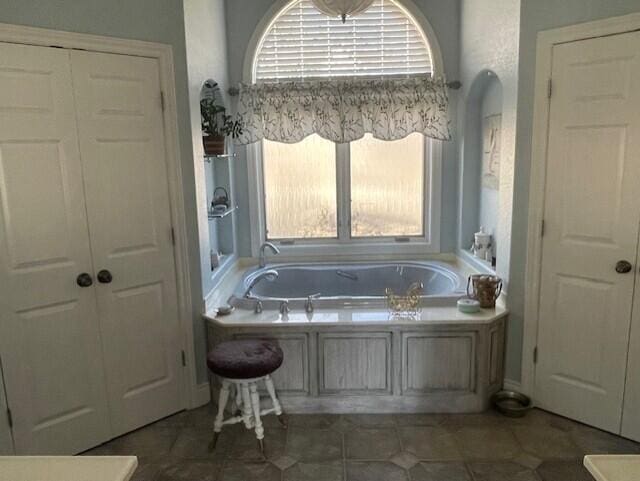 bathroom featuring tile patterned flooring and a tub