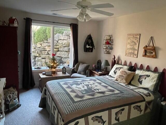 bedroom with ceiling fan and carpet floors