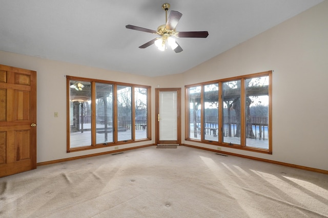 unfurnished room with ceiling fan, light colored carpet, and vaulted ceiling