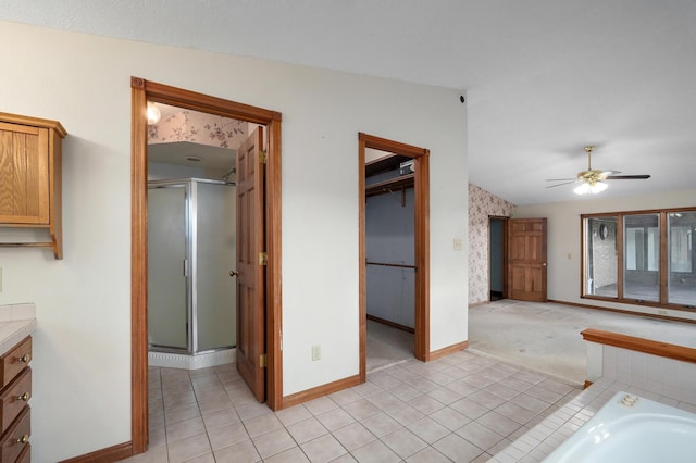 bathroom featuring ceiling fan, plus walk in shower, tile patterned floors, lofted ceiling, and vanity