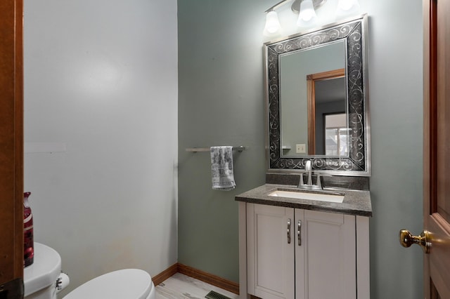 bathroom with vanity and toilet