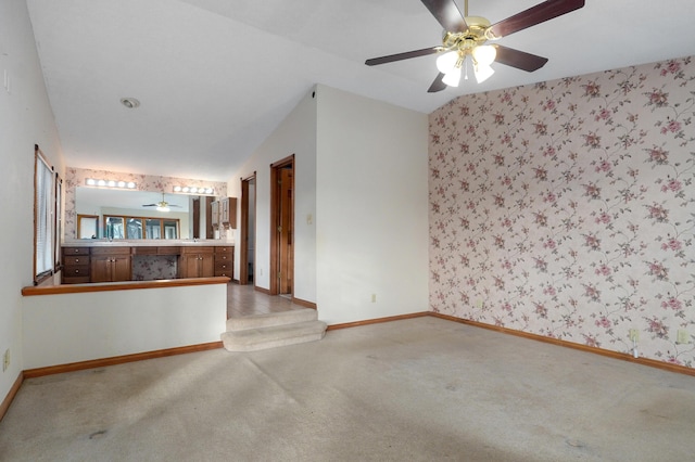 unfurnished living room with ceiling fan, lofted ceiling, and carpet floors