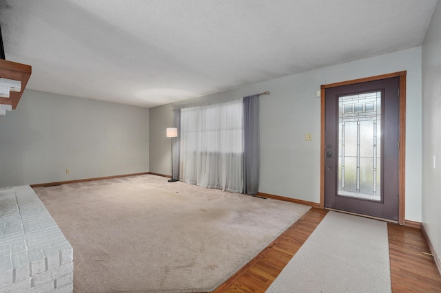 entryway featuring light hardwood / wood-style floors and a textured ceiling