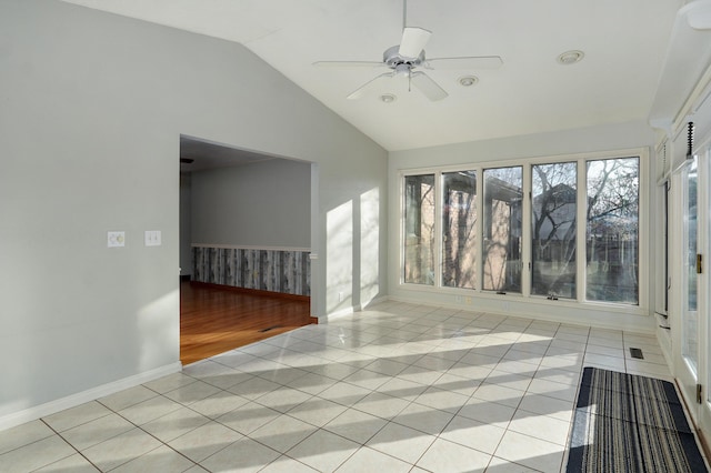 unfurnished sunroom featuring ceiling fan and vaulted ceiling