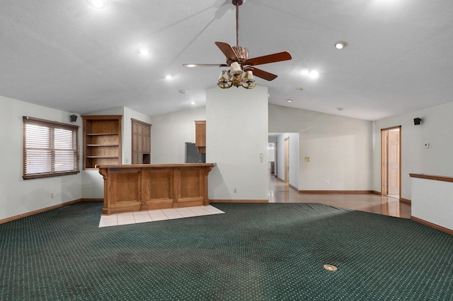 kitchen with light carpet, vaulted ceiling, ceiling fan, and stainless steel refrigerator