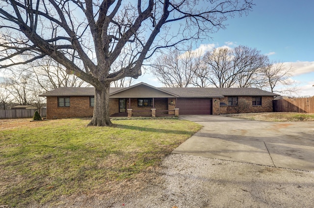 single story home with a garage and a front lawn