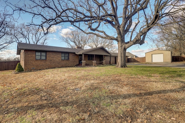 ranch-style home featuring a garage, an outdoor structure, and a front lawn