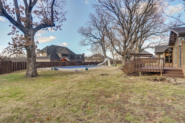 view of yard with a swimming pool side deck