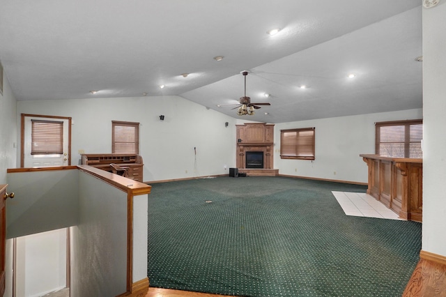 unfurnished living room with a fireplace, ceiling fan, light hardwood / wood-style flooring, and vaulted ceiling