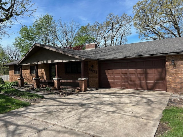 view of front of house featuring brick siding, a garage, a chimney, concrete driveway, and covered porch