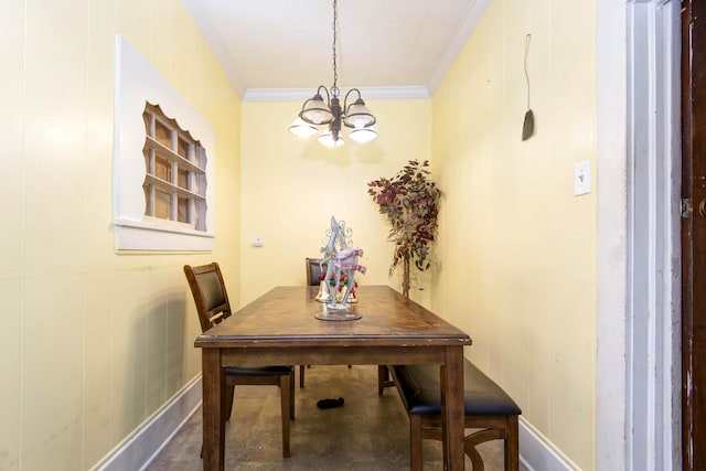 dining room featuring crown molding, wooden walls, concrete floors, and a notable chandelier